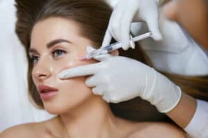 Young woman receiving a Bio-LIFT® injection treatment for anti-aging and skin rejuvenation at a cosmetic salon